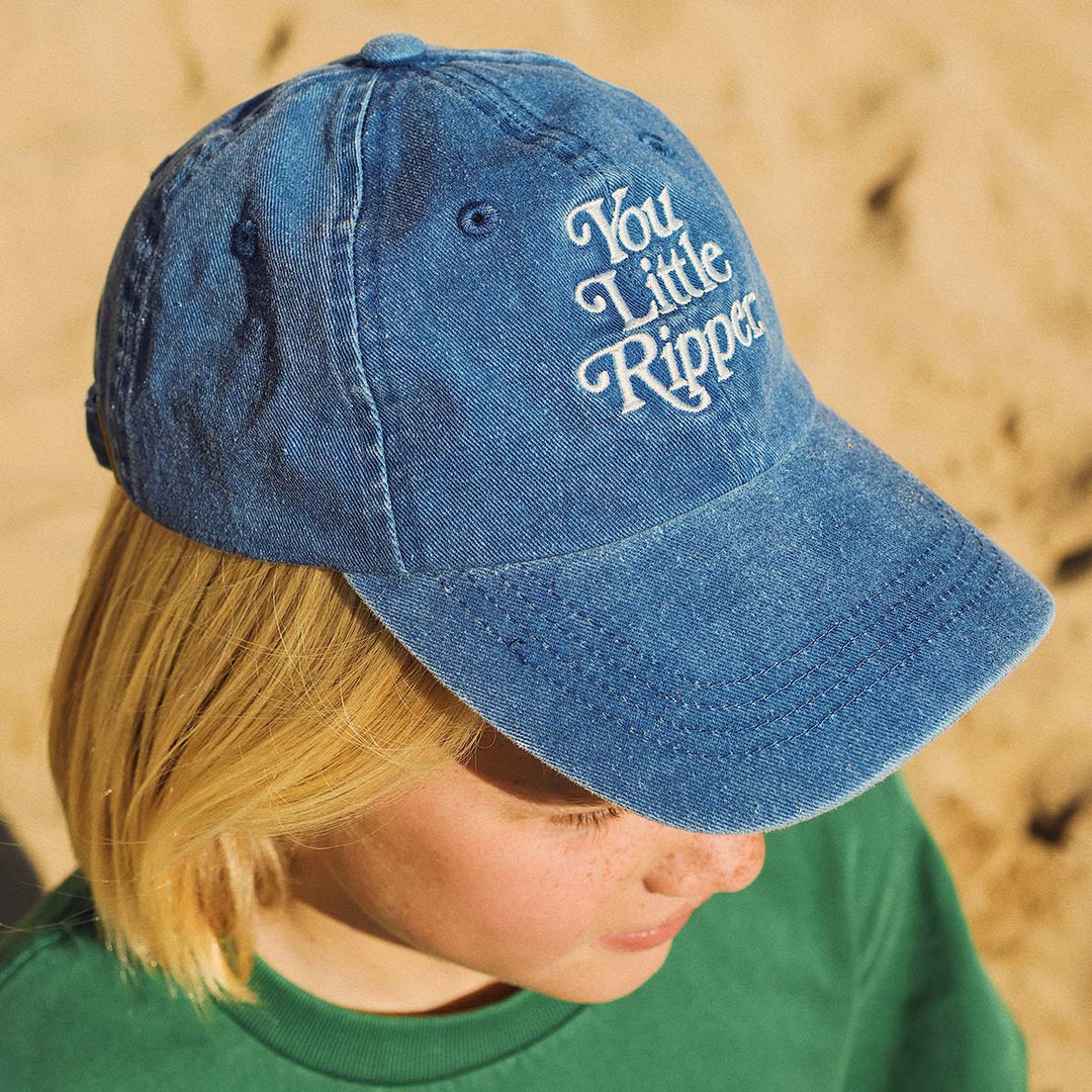 Boy wearing the You Little Ripper kids cotton cap in blue