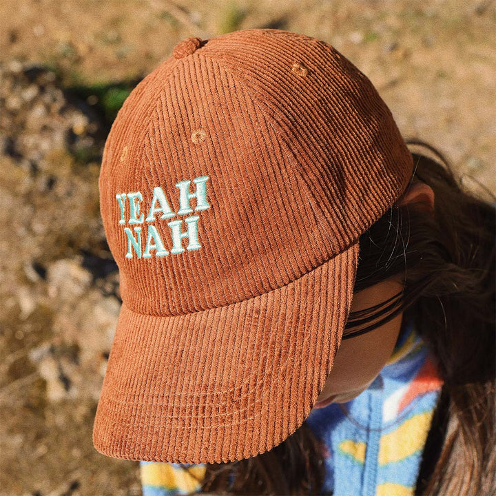 Close up of the Yeah Nah embroidery on the tobacco corduroy kids cap