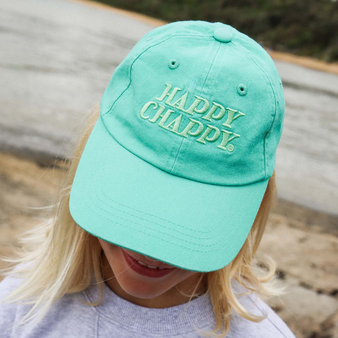 Close up of the Happy Chappy embroidery on the green kids cotton cap