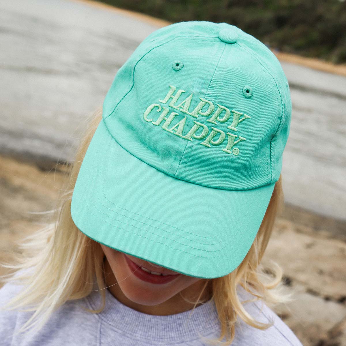 Close up of the Happy Chappy embroidery on the green kids cotton cap