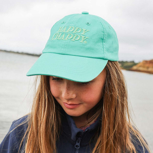 Girl wearing the Happy Chappy kids cotton cap in green