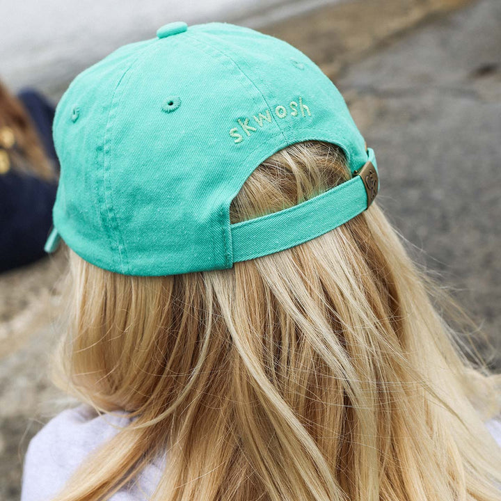 Back of the Happy Chappy kids cotton cap in green with its adjustable strap