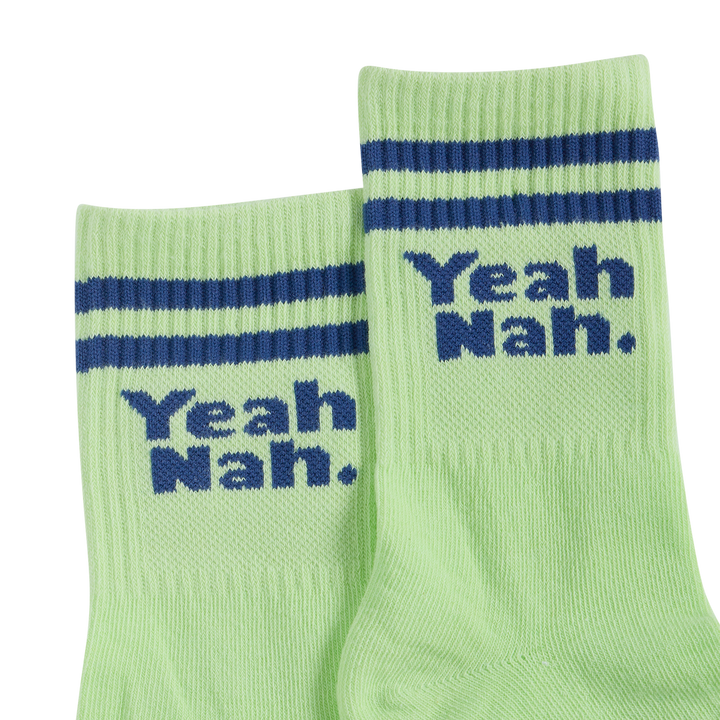 Pair of Yeah Nah kids crew socks in lime