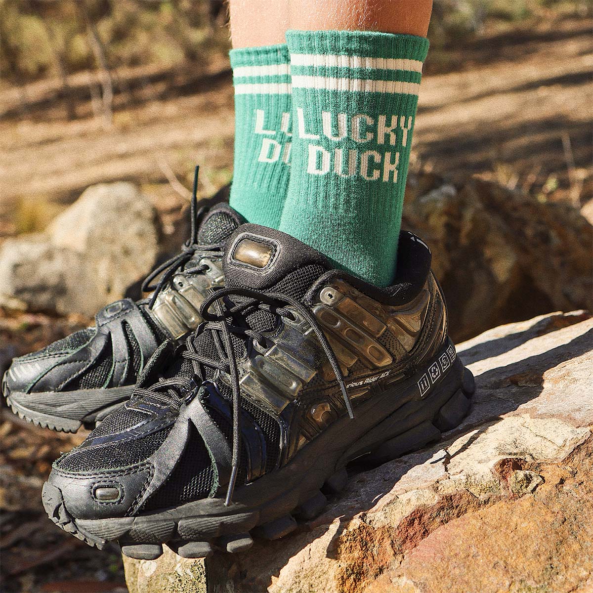 Kids Lucky Duck socks in green worn with hiking boots