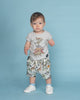 A baby boy wearing a Rock your Baby Online JUNGLE LIFE BABY SKATE SHORTS t-shirt and shorts.