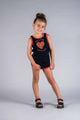 a little girl in an ELECTRIC HEART ROMPER by Rock your Baby Online posing for a photo.