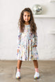 A little girl wearing a Rock your Baby Online SORBET UNICORN WAISTED DRESS.