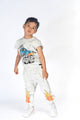A young boy wearing a Rock your Baby Online MONSTER TRUCK TRACK PANTS and t-shirt.