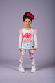 A little girl wearing Rock your Baby Online's Ballet Balloons Tights, a floral top and leggings.