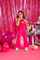 A girl in a BARBIE SILHOUETTE JUMPSUIT from Rock your Baby Online posing in front of balloons.