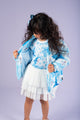 a little girl wearing a blue and white dress and the Elsa Magic Puffer Jacket by Rock your Baby Online.